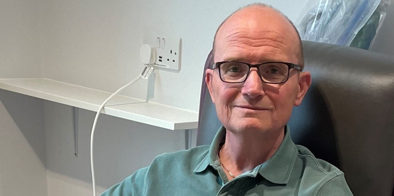Man in glasses receiving treatment on a cancer vaccine clinical trial
