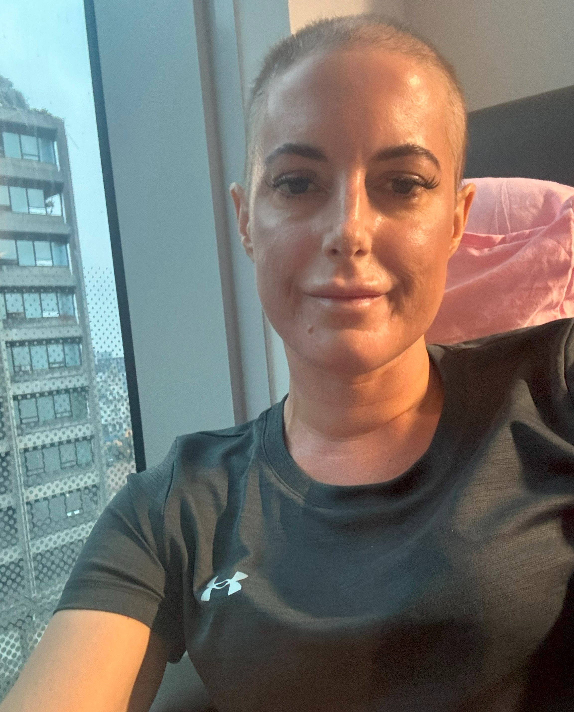 Catherine is taking a selfie while having her treatment in hospital