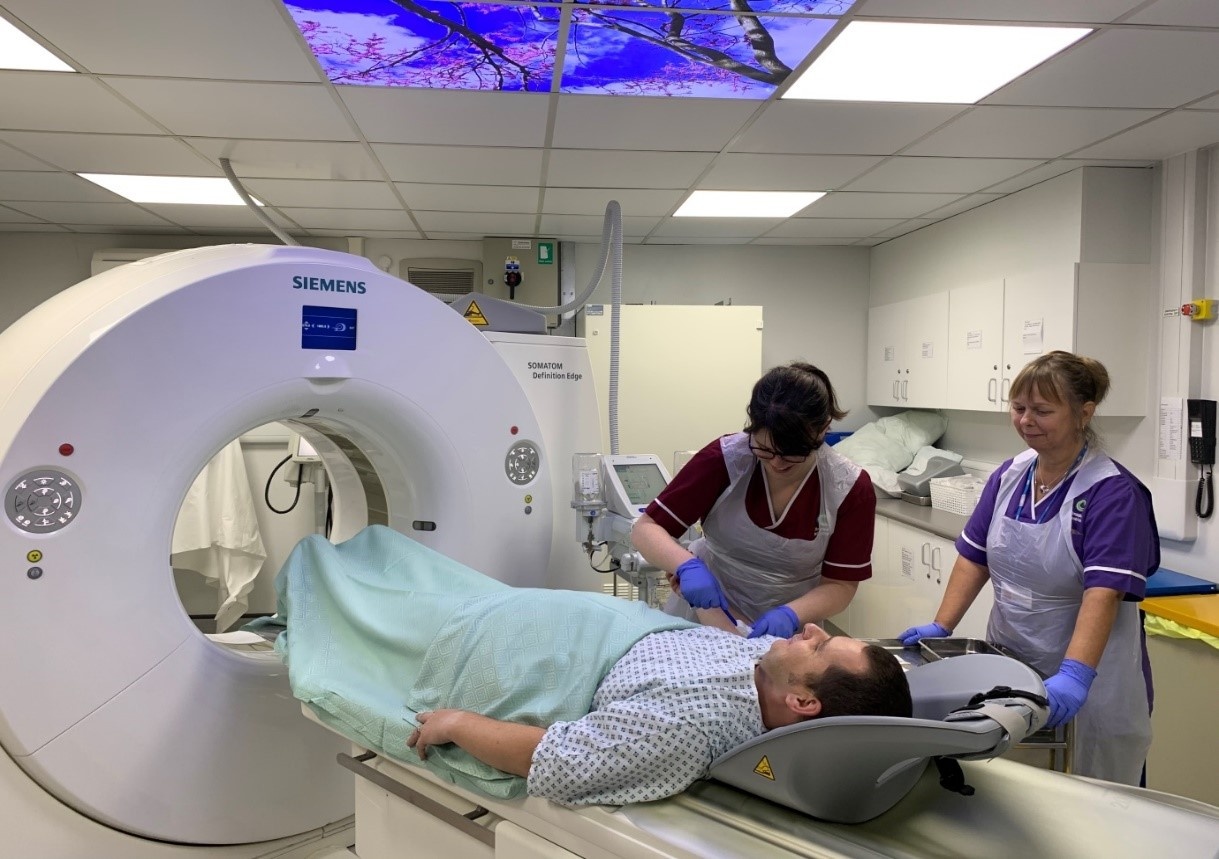 CT scanner couch staff and patient.jpg