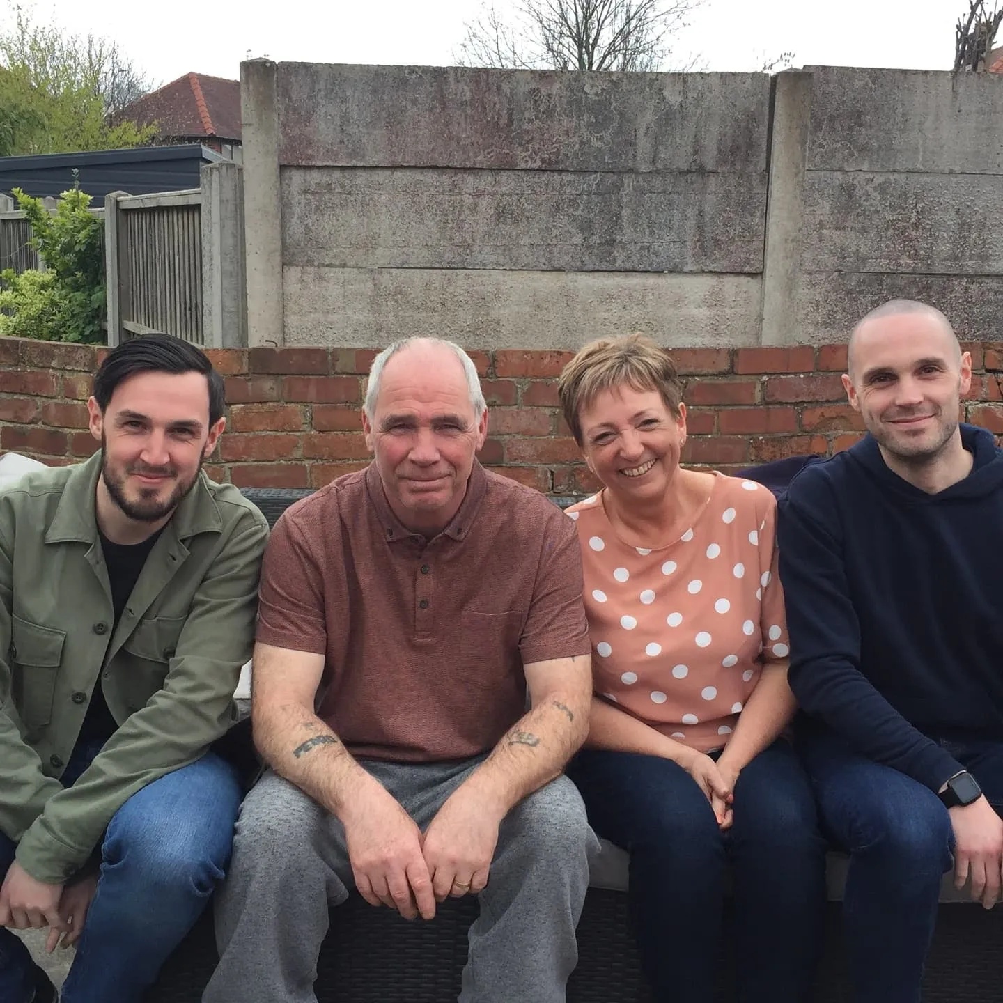 Adam (left) before his diagnosis with his family.jpg